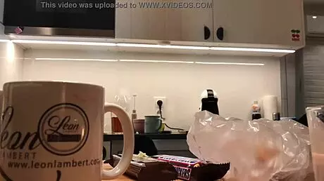 Young amateur wife does dishes while voyeur cam captures her in tight leggings and thong