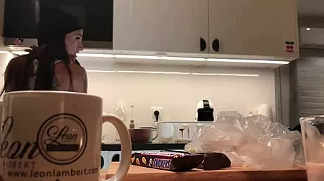 Young amateur wife does dishes while voyeur cam captures her in tight leggings and thong