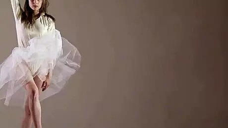 Blonde gymnast just casually showing off moves in a naked workout.